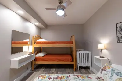 a bedroom with two bunk beds and a mirror at Spectacular Buckleberry View EV Recharge Hot Tub Fireplace Jacuzzi in Spring Mills