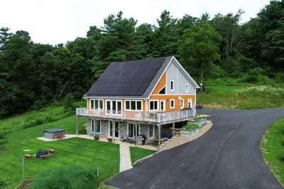 an aerial view of a house with a solar roof at Spectacular Buckleberry View EV Recharge Hot Tub Fireplace Jacuzzi in Spring Mills