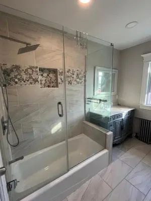 a bathroom with a shower with a tub and a sink at Grand Bergen Home Near NYC-Shops in Maywood