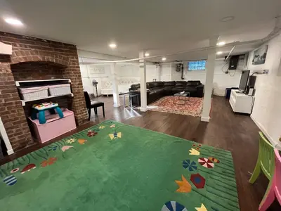a living room with a couch and a fireplace at Grand Bergen Home Near NYC-Shops in Maywood