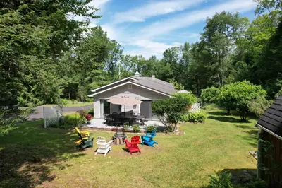 a group of chairs in a yard with a house at Catskills Getaway 3BR Retreat with Media Room, Near Casino, Bethel Woods and More in Glen Wild