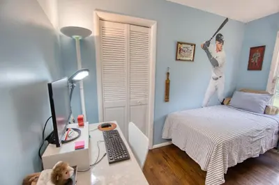 a room with a bed with a man hanging on the wall at Catskills Getaway 3BR Retreat with Media Room, Near Casino, Bethel Woods and More in Glen Wild