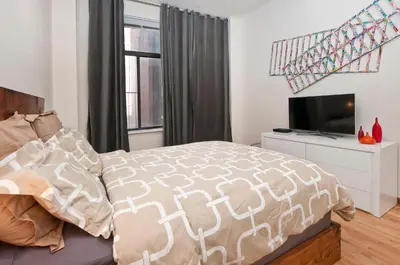 a bedroom with a bed and a television at Luxury Apartments Next to Times Square in New York