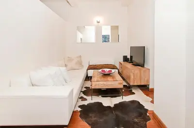 a living room with a white couch and a table at Luxury Apartments Next to Times Square in New York