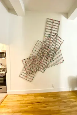a wall with a bunch of wine racks on a wall at Luxury Apartments Next to Times Square in New York
