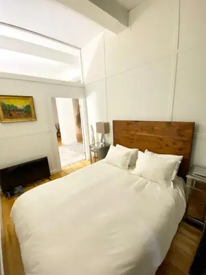 a bedroom with a large white bed with white pillows at Luxury Apartments Next to Times Square in New York