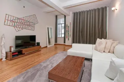 a living room with a white couch and a tv at Luxury Apartments Next to Times Square in New York