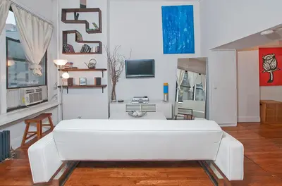 a bedroom with a large white bed in a room at Luxury Apartments Next to Times Square in New York