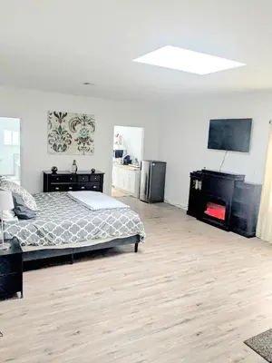 a bedroom with a bed and a television in it at Cozy Guesthouse in Catasauqua