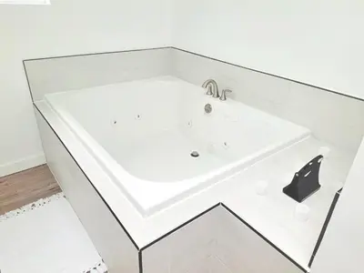 a white bath tub in a room with a sink at Cozy Guesthouse in Catasauqua