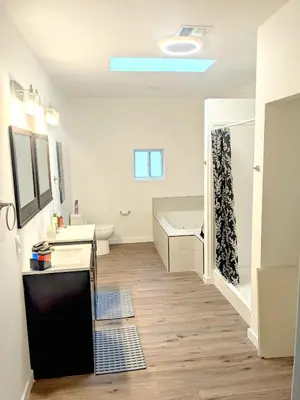 a bathroom with a tub and a sink and a shower at Cozy Guesthouse in Catasauqua