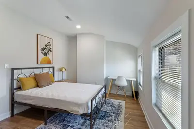 a bedroom with a bed and a window at Welcome to The Lux Collective a Spacious 5-Bedroom House close to Stadiums, Universities, Center City & more! in Philadelphia