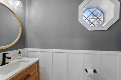 a bathroom with a sink and a mirror at Welcome to The Lux Collective a Spacious 5-Bedroom House close to Stadiums, Universities, Center City & more! in Philadelphia