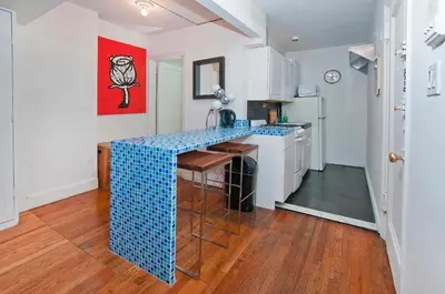 a kitchen with a blue counter top in a room at Mid Town East Street Apartments Next to Times Square in New York