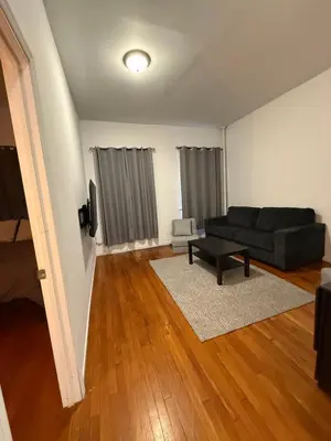 a living room with a couch and a table at Mid Town East Street Apartments Next to Times Square in New York