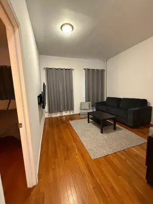 a living room with a couch and a table at Mid Town East Street Apartments Next to Times Square in New York