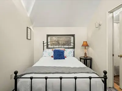 a bedroom with a large bed with blue pillows at Memorabile Getaway Fire-Pit and Entrainment Area in Long Pond