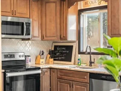 a kitchen with a stove and a sink and a microwave at Memorabile Getaway Fire-Pit and Entrainment Area in Long Pond