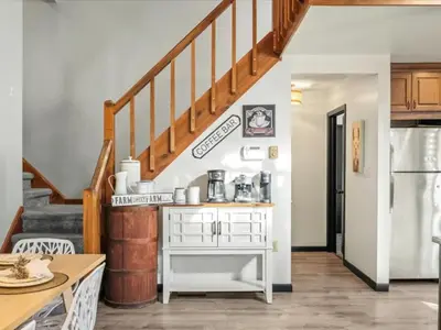 a kitchen with a staircase and a white table at Memorabile Getaway Fire-Pit and Entrainment Area in Long Pond