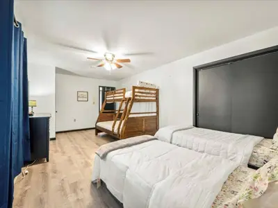 a bedroom with a bed and a ceiling fan at Memorabile Getaway Fire-Pit and Entrainment Area in Long Pond