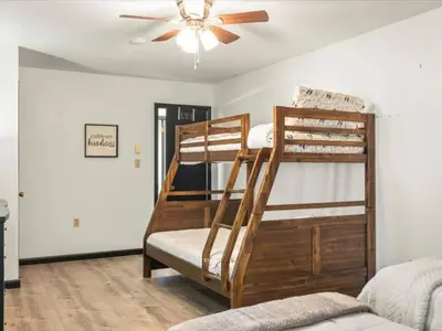 two bunk beds in a room with a ceiling fan at Memorabile Getaway Fire-Pit and Entrainment Area in Long Pond