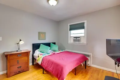 a bedroom with a bed and a dresser and a tv at 5 Mi to Dtwn Newark Hillside Vacation Rental in Hillside