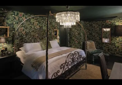 a bedroom with a bed and a chandelier at Carversville Inn in New Hope
