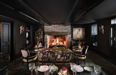 a dining room with a fireplace and a table and chairs at Carversville Inn in New Hope