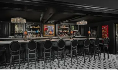 a bar with black walls and black chairs at Carversville Inn in New Hope