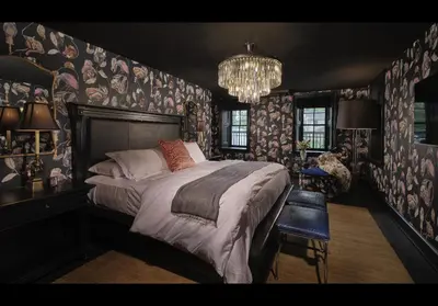 a bedroom with a large bed and a chandelier at Carversville Inn in New Hope