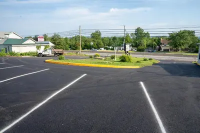 an empty parking lot with a car parked in it at Rainbow Motel in Douglassville