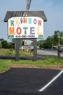 a sign for a random motel on the side of a road at Rainbow Motel in Douglassville
