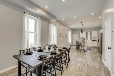 a dining room and kitchen with a table and chairs at Group Getaway with Games and Patio in Philadelphia! in Philadelphia