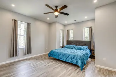 a bedroom with a bed and a ceiling fan at Group Getaway with Games and Patio in Philadelphia! in Philadelphia