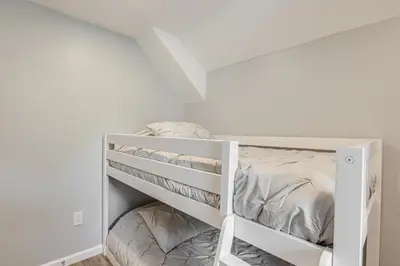 a white bunk bed in a white room at Group Getaway with Games and Patio in Philadelphia! in Philadelphia