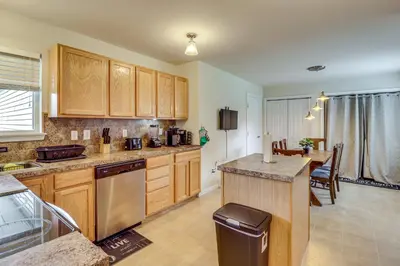 a kitchen with wooden cabinets and a counter top at Family Retreat with 2 Game Rooms and Deck in Long Pond in Long Pond