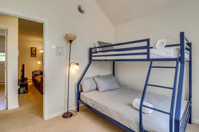 a bedroom with two bunk beds in a room at Family Retreat with 2 Game Rooms and Deck in Long Pond in Long Pond