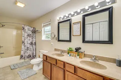 a bathroom with two sinks and a toilet and a shower at Family Retreat with 2 Game Rooms and Deck in Long Pond in Long Pond