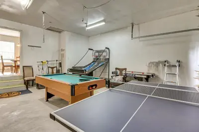 a room with a ping pong table and a trampoline at Family Retreat with 2 Game Rooms and Deck in Long Pond in Long Pond