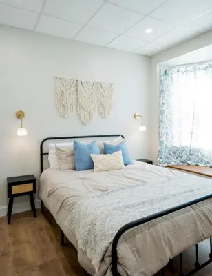 a bedroom with a large bed with blue pillows at Cozy Corner Near UPMC & Downtown in Williamsport