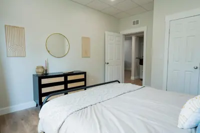 a bedroom with a bed and a mirror on the wall at Cozy Corner Near UPMC & Downtown in Williamsport