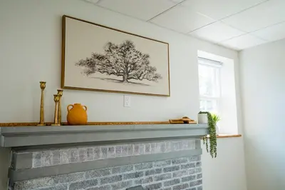 a picture of a tree above a fireplace at Cozy Corner Near UPMC & Downtown in Williamsport