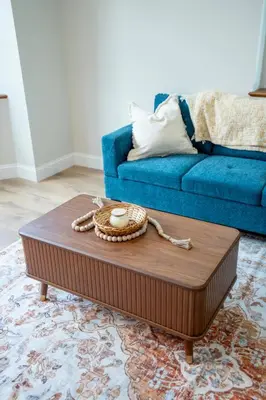 a living room with a blue couch and a coffee table at Cozy Corner Near UPMC & Downtown in Williamsport