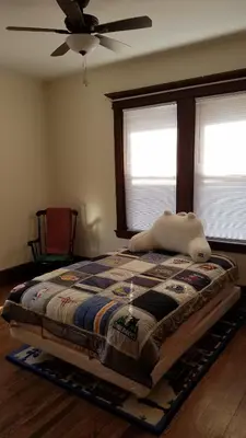 a bed in a bedroom with a ceiling fan at Weehawken on Hudson in Union City