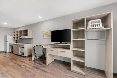 an office with a desk with a tv and a computer at WoodSpring Suites Wilmington Riverfront in Wilmington