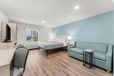 a living room with a couch and a bed at WoodSpring Suites Wilmington Riverfront in Wilmington