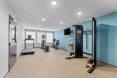 a gym with several tread machines in a room at WoodSpring Suites Wilmington Riverfront in Wilmington