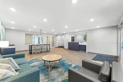 a living room with a couch and a table at WoodSpring Suites Wilmington Riverfront in Wilmington