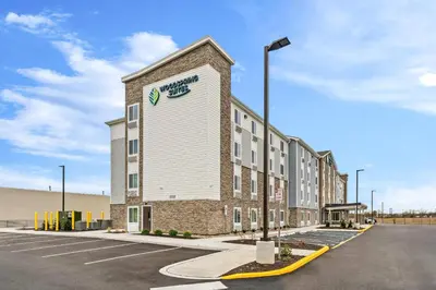a building with a clock on the side of it at WoodSpring Suites Wilmington Riverfront in Wilmington