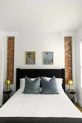 a bedroom with a white bed with three pictures on the wall at Quiet close to NYC BBQ Deck in Jersey City